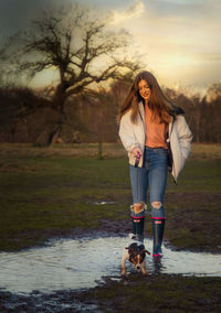 Full length of woman with dog