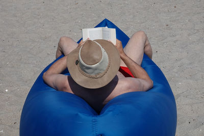 High angle view of hand holding hat