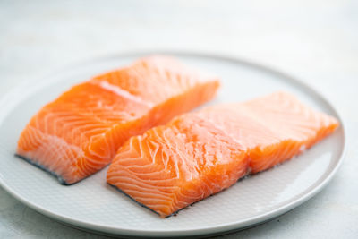 Fresh salmon fillet on a plate for delicious salmon steak.