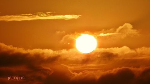 Low angle view of sun in sky during sunset