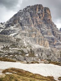 Late morning sun above sharp snowy alpine cliffs above valley. sharp cliffs at horizon. mountains 