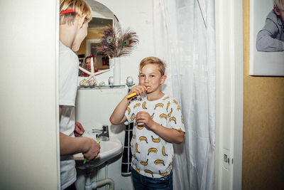 Portrait of boy brushing teeth in morning