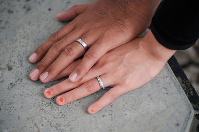 Holding hands with engagement ring on finger