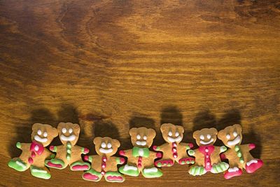 Gingerbread teddy bear arranged on bottom of wooden table