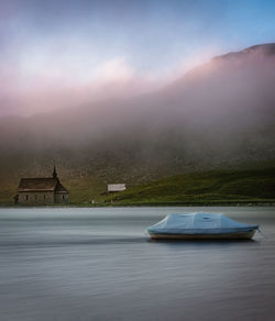 Boat in foggy weather at sunset