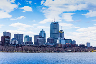 Buildings in city against cloudy sky