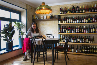 Portrait of man with beer bottles on table