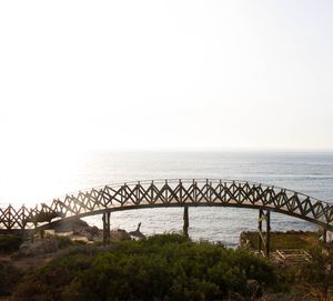 View of bridge over sea against clear sky