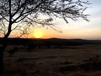 Scenic view of silhouette landscape against sky at sunset