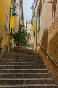 Low angle view of staircase amidst buildings in city