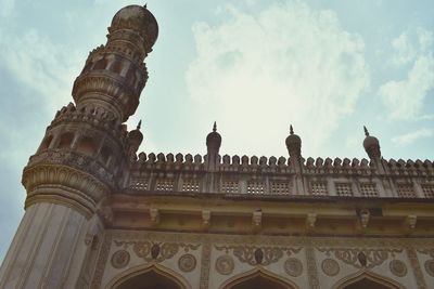 Low angle view of historical building against cloudy sky