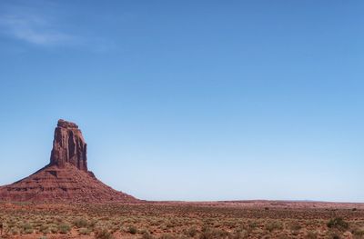 Landscape of one red rock butte and desert greenery in arizona