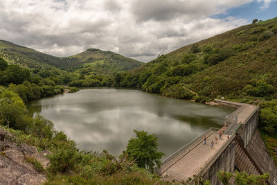 Scenic view of lake and mountains against sky