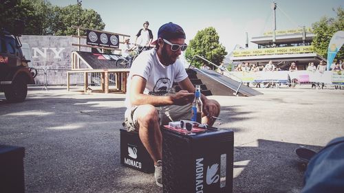 Full length of man sitting on bench