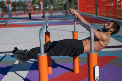 Rear view of man exercising in gym