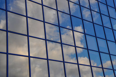 Full frame shot of glass building against sky