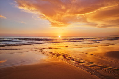 Atlantic ocean sunset with surging waves at fonte da telha beach, portugal