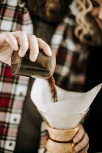 Close-up of hand pouring tea