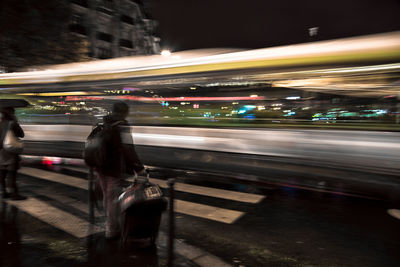 Blurred motion of man on road at night