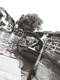 Boats in river with buildings in background