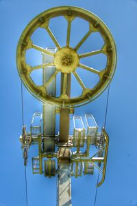 Low angle view of ferris wheel against blue sky