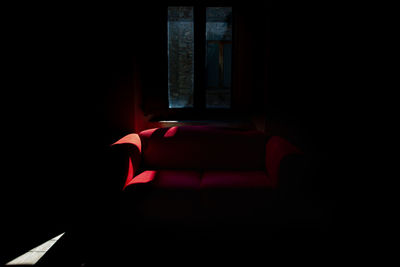 Empty chair in dark room