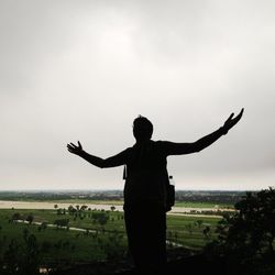 Silhouette of woman standing on field