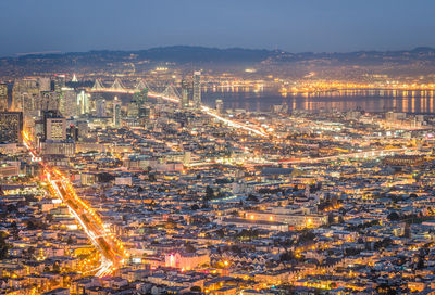 High angle view of illuminated city buildings at night