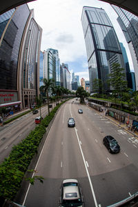 View of city street and buildings against sky