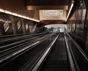 Interior of illuminated escalator stairs in a subway station