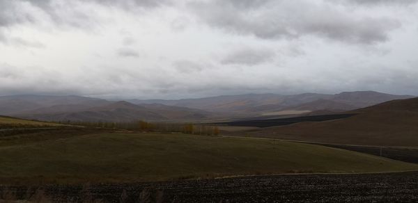 Scenic view of landscape and mountains against sky