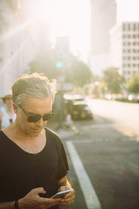 Man looking at car on street in city
