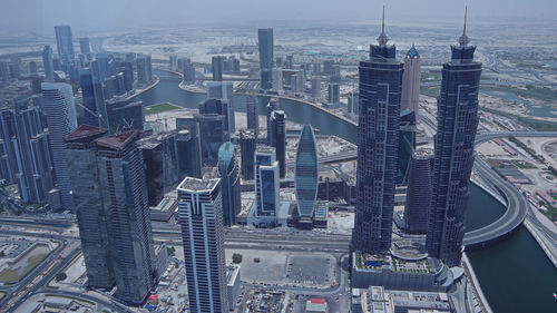 High angle view of modern buildings in city against sky