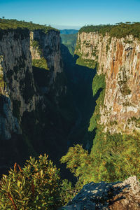 Itaimbezinho canyon with steep rocky cliffs going through a flat plateau, in cambará do sul, brazil.