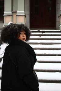 Close-up of boy standing against wall