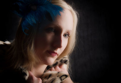 Close-up portrait of a girl over black background