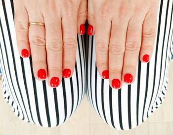 Close-up of woman hand with red nail polish