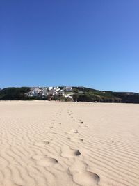 View of desert against clear blue sky