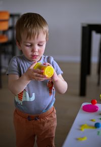 Portrait of little toddler playing at the table