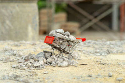 Selective focus on shopping trolley carries the crushed stones and pouring onto the pile at the site