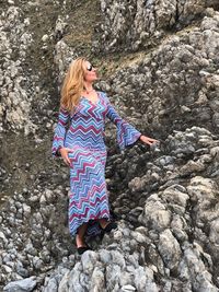 Mature woman standing on rocks