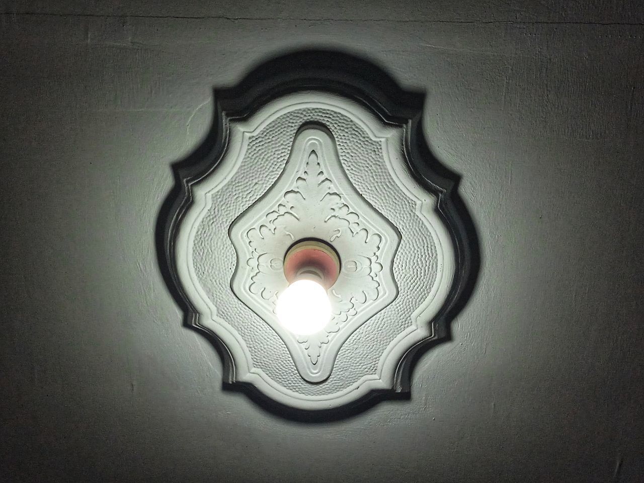 LOW ANGLE VIEW OF ILLUMINATED LAMP AGAINST WALL