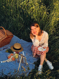 Portrait of young woman standing by plants