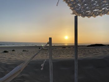 Scenic view of beach against sky during sunset