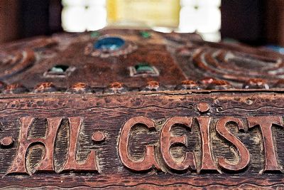 Close-up of old cross on wood