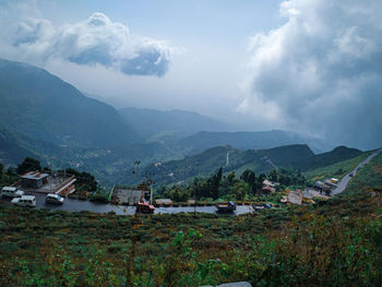 Scenic view of houses and mountains against sky