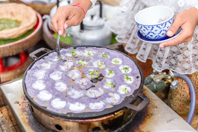 Cropped image of woman serving food