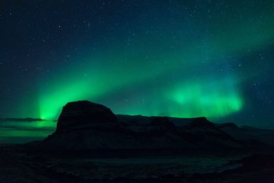 Scenic view of mountains against sky at night