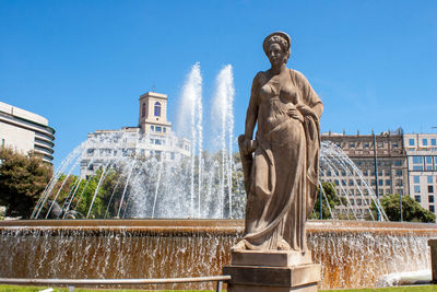 Low angle view of statue against fountain