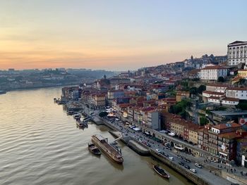 Old town porto view from the bridge. medieval ribeira, boats and douro river. sunset, twilight 